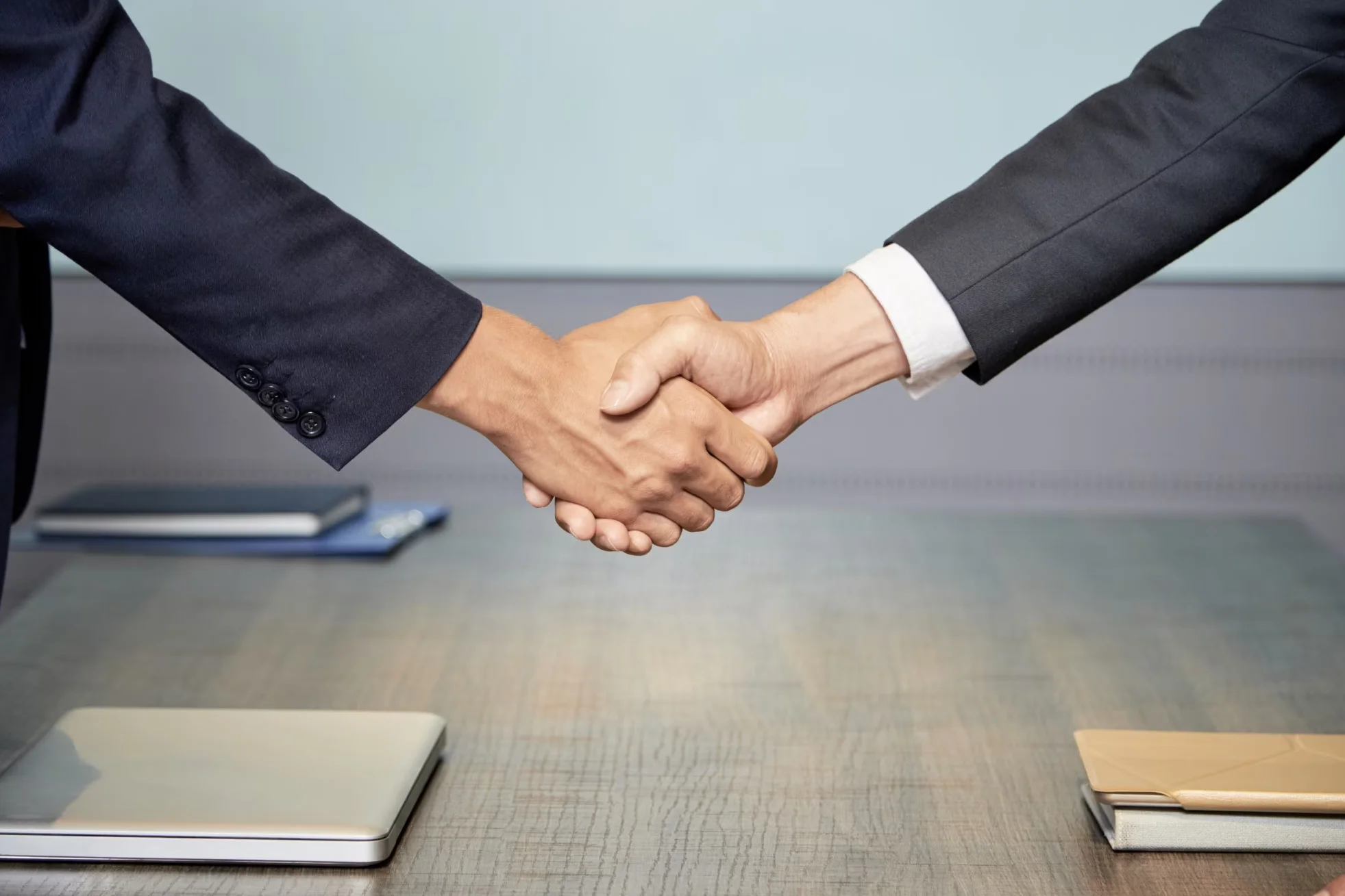 crop people shaking hands on conference