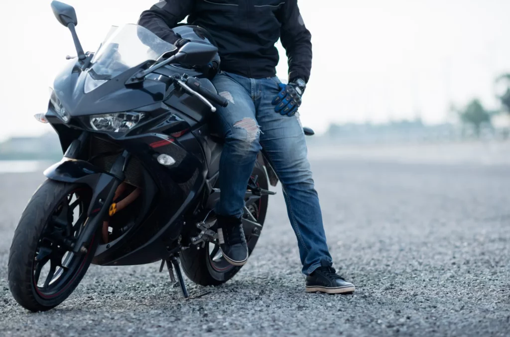 motorbiker with helmet in hands of motorcycle